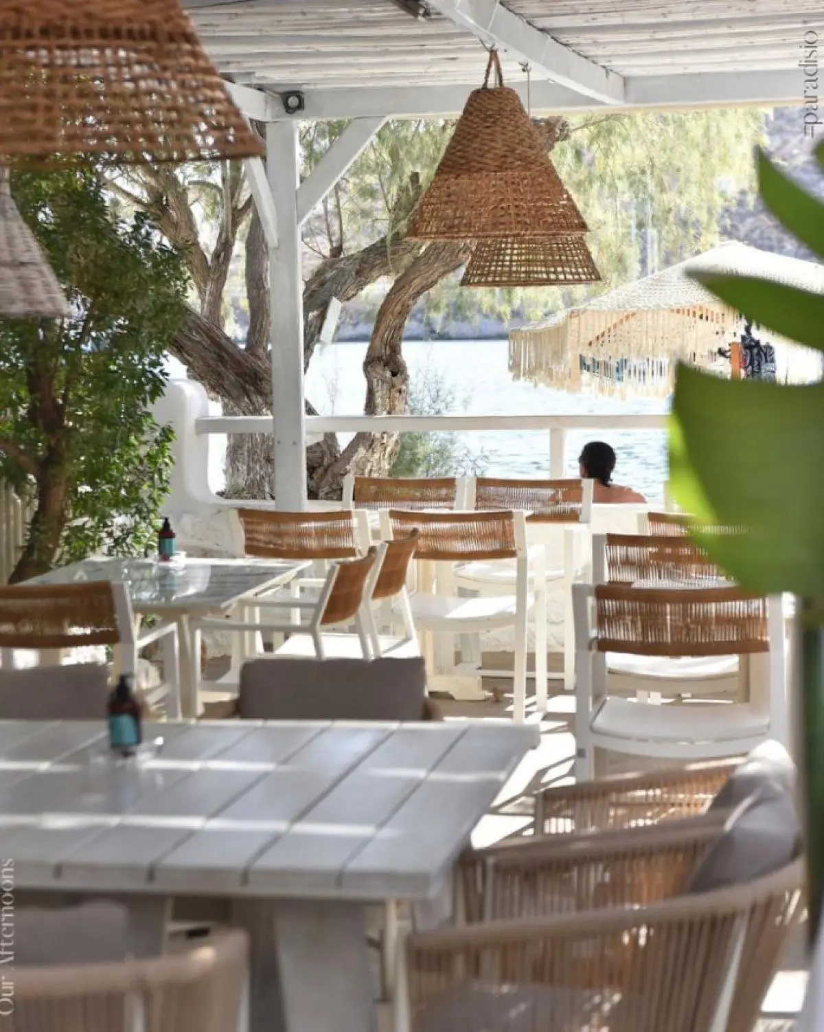 The shaded terrace at Paradisio with wicker lamps